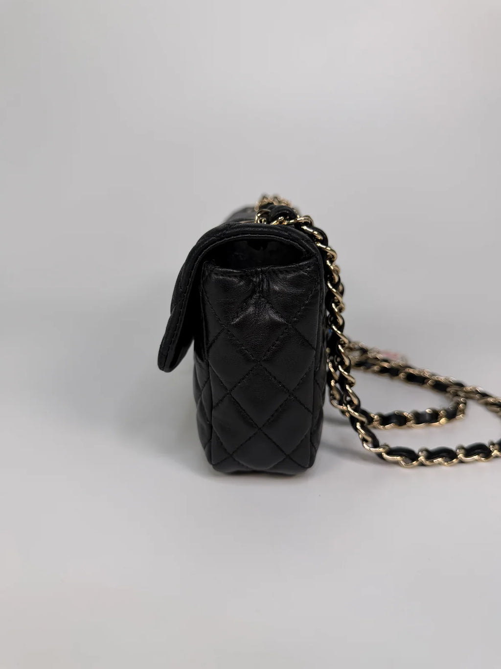 CHANEL EAST WEST CHARMS BAG IN BLACK LAMBSKIN LEATHER WITH GOLD HARDWARE
