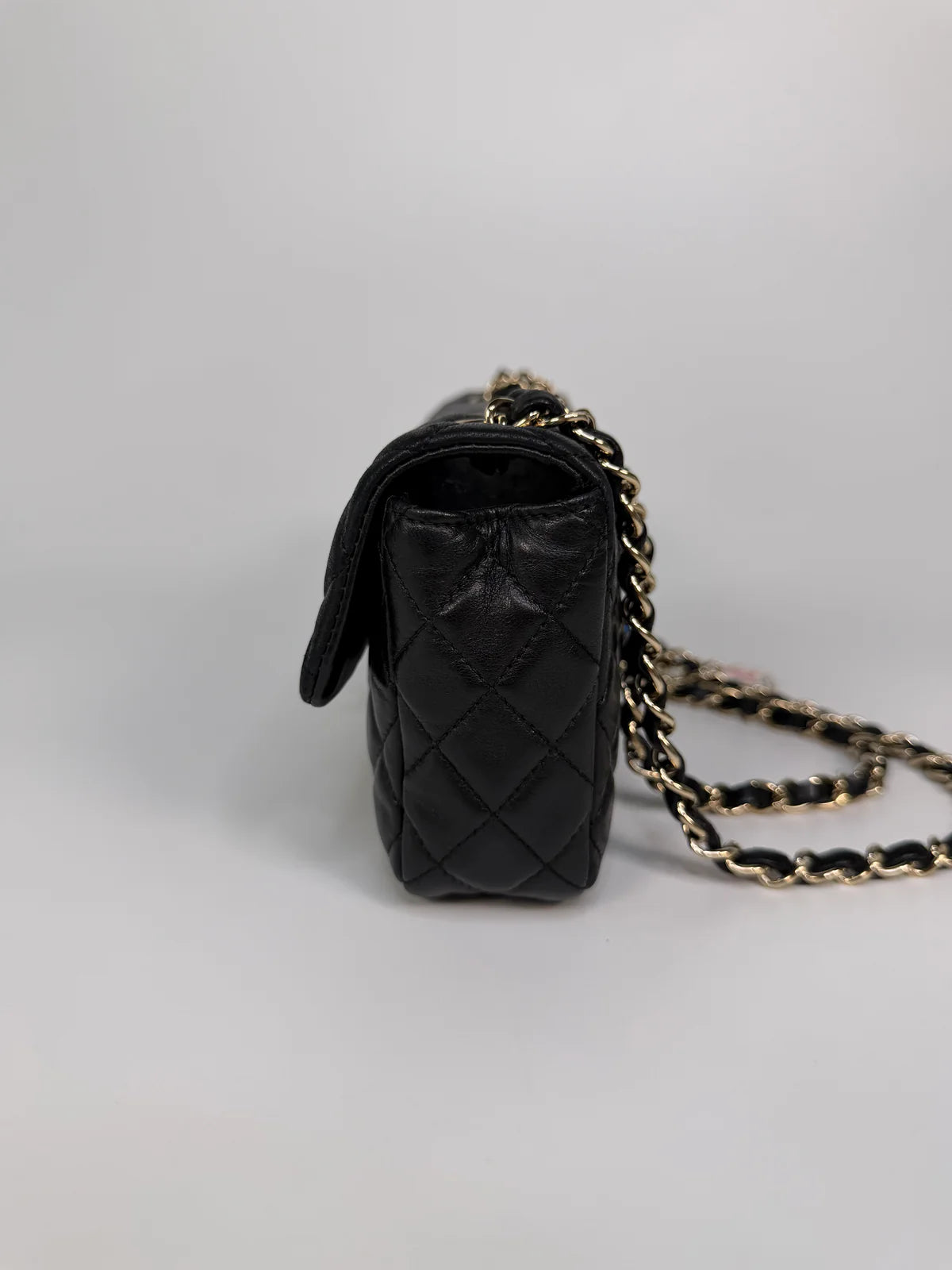 CHANEL EAST WEST CHARMS BAG IN BLACK LAMBSKIN LEATHER WITH GOLD HARDWARE