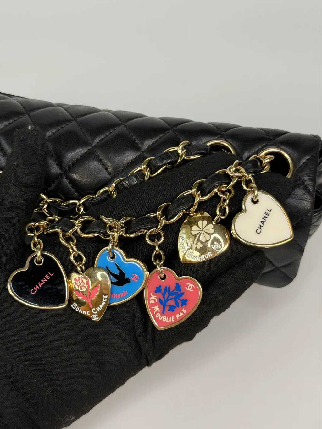 CHANEL EAST WEST CHARMS BAG IN BLACK LAMBSKIN LEATHER WITH GOLD HARDWARE