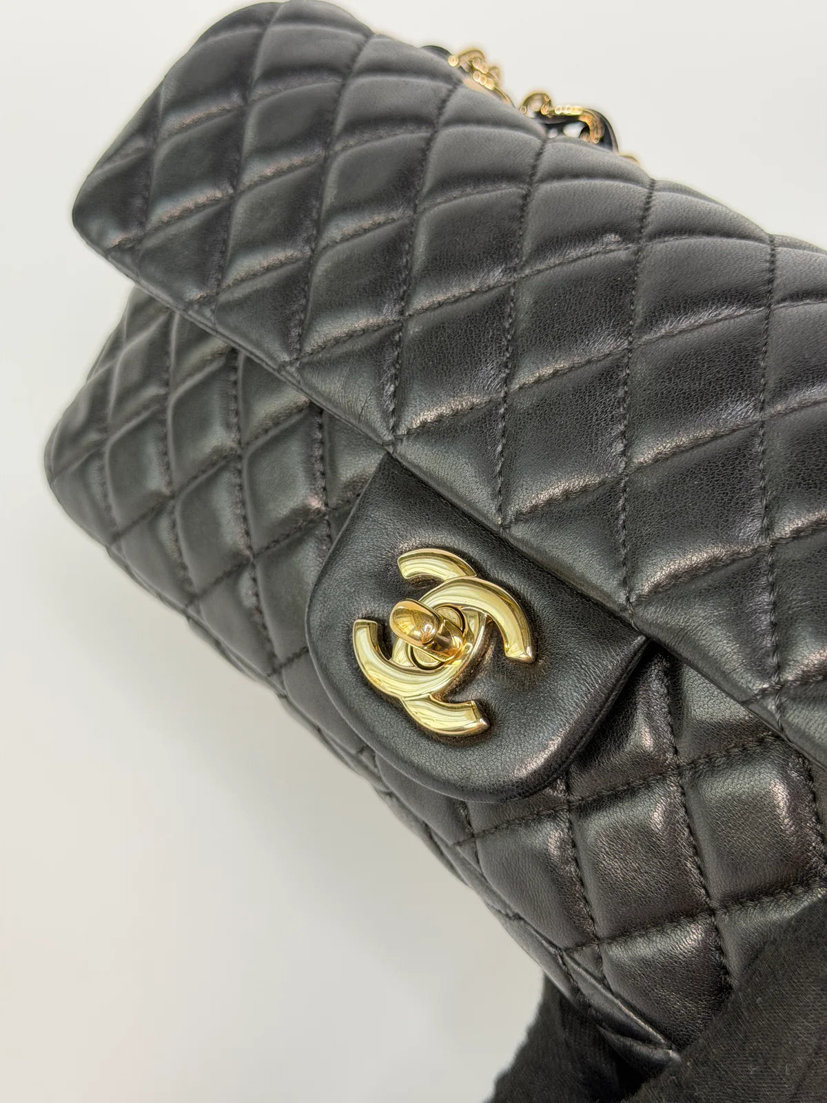 CHANEL EAST WEST CHARMS BAG IN BLACK LAMBSKIN LEATHER WITH GOLD HARDWARE