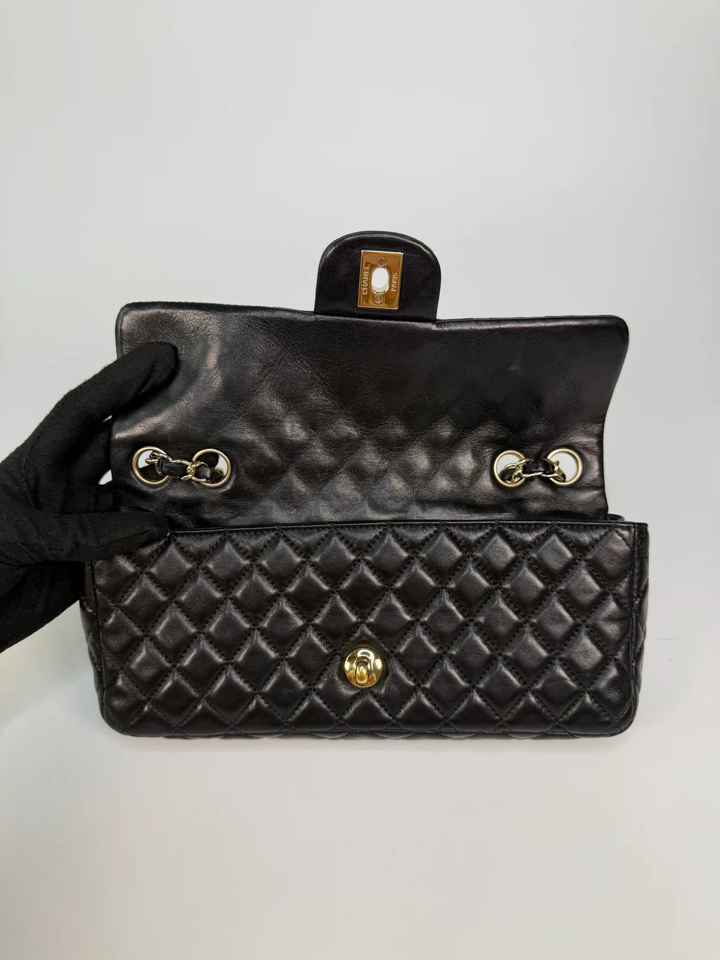 CHANEL EAST WEST CHARMS BAG IN BLACK LAMBSKIN LEATHER WITH GOLD HARDWARE