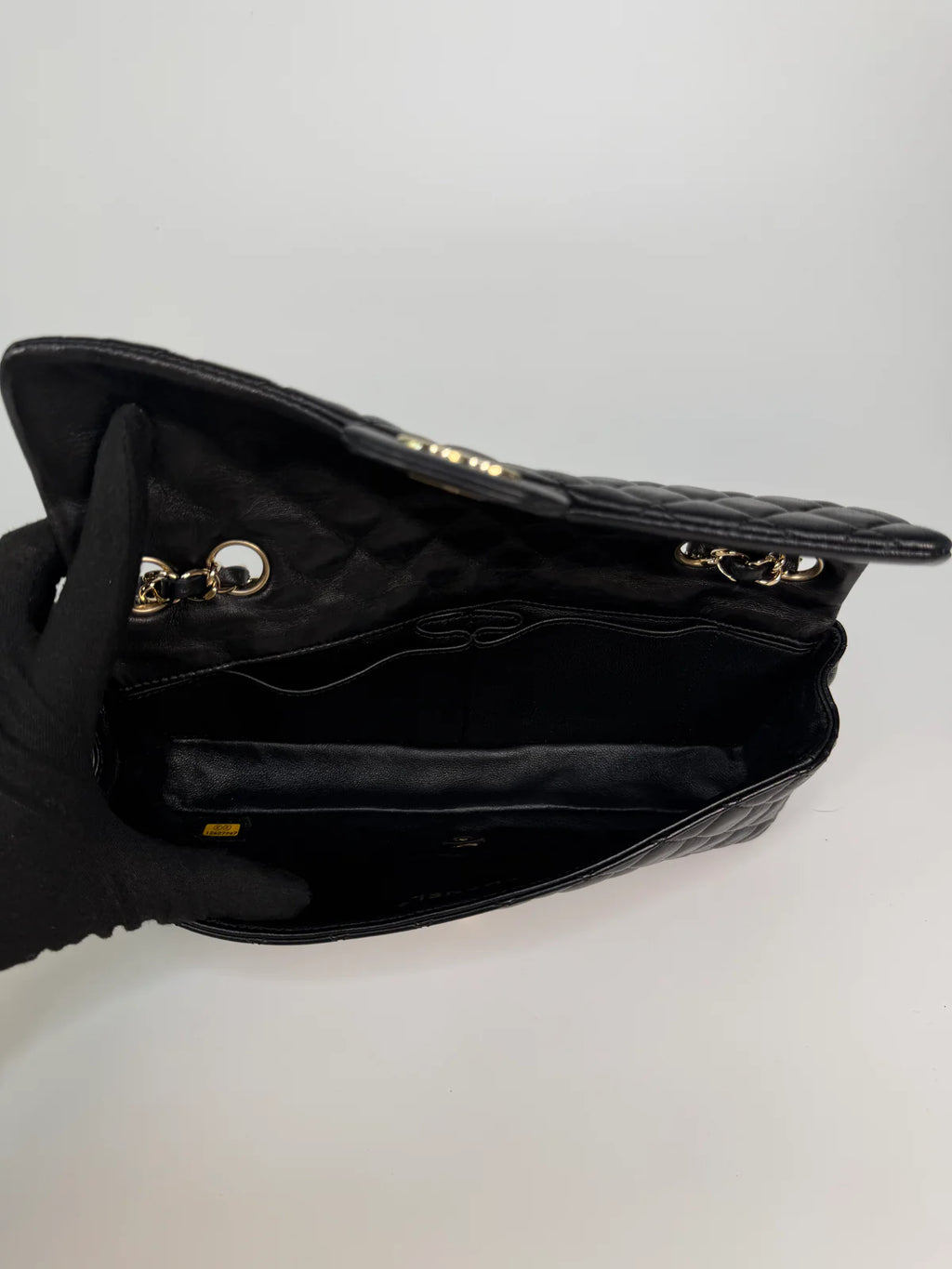 CHANEL EAST WEST CHARMS BAG IN BLACK LAMBSKIN LEATHER WITH GOLD HARDWARE